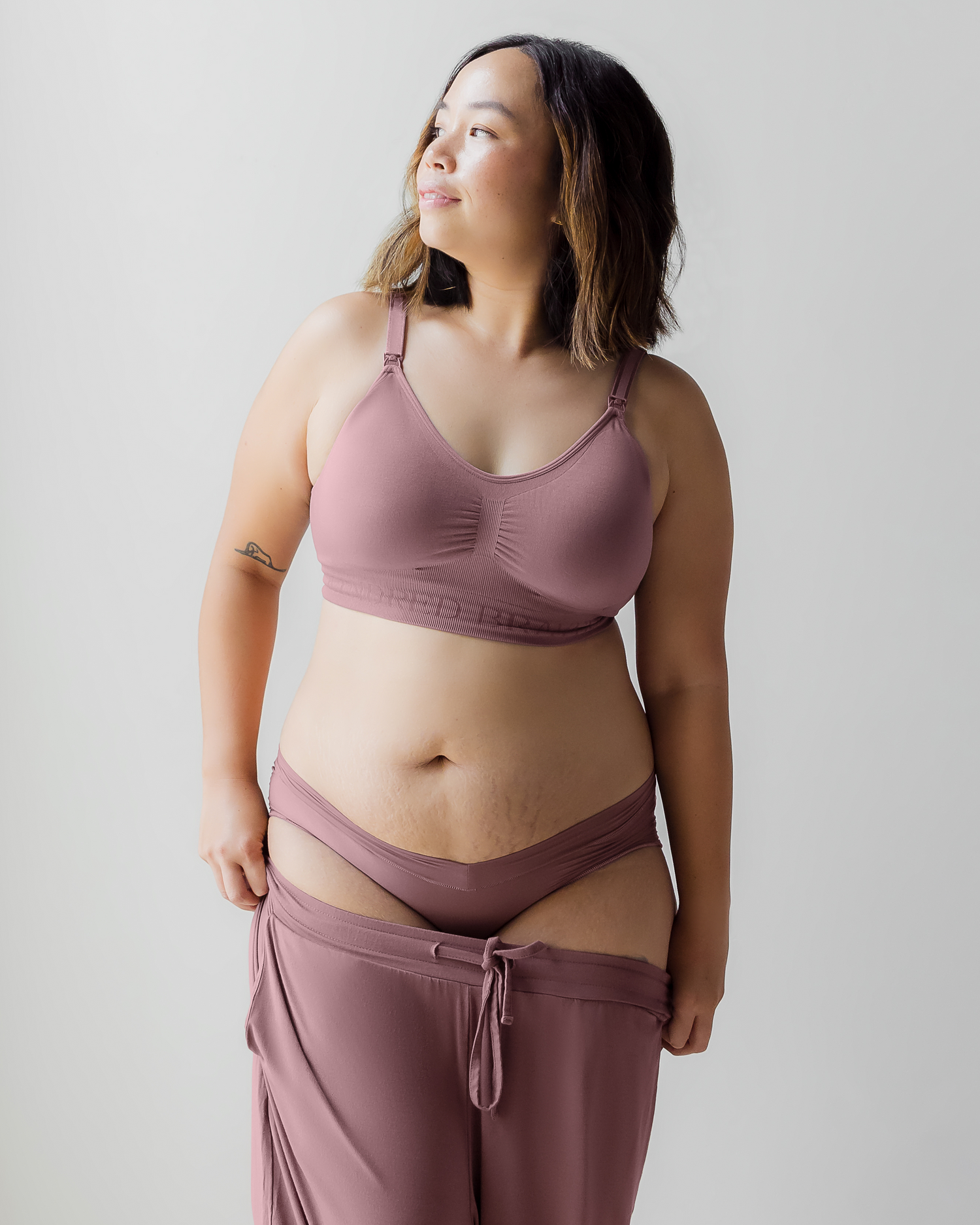 Front view of model wearing the Grow With Me Hipster in Twilight, with matching Simply Sublime Nursing Bra and Everyday Lounge Jogger being pulled up