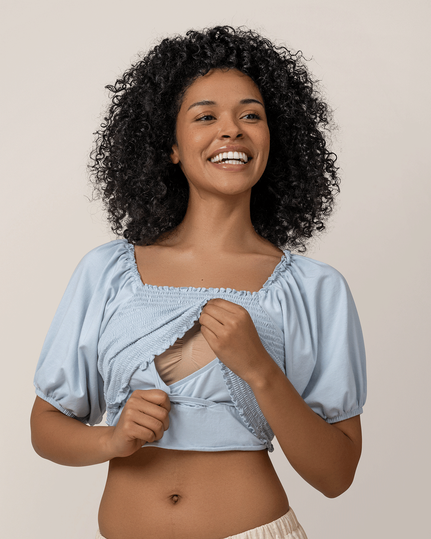 Front view of model wearing Sophia Smocked Cropped Nursing Top in French Blue, showing nursing access