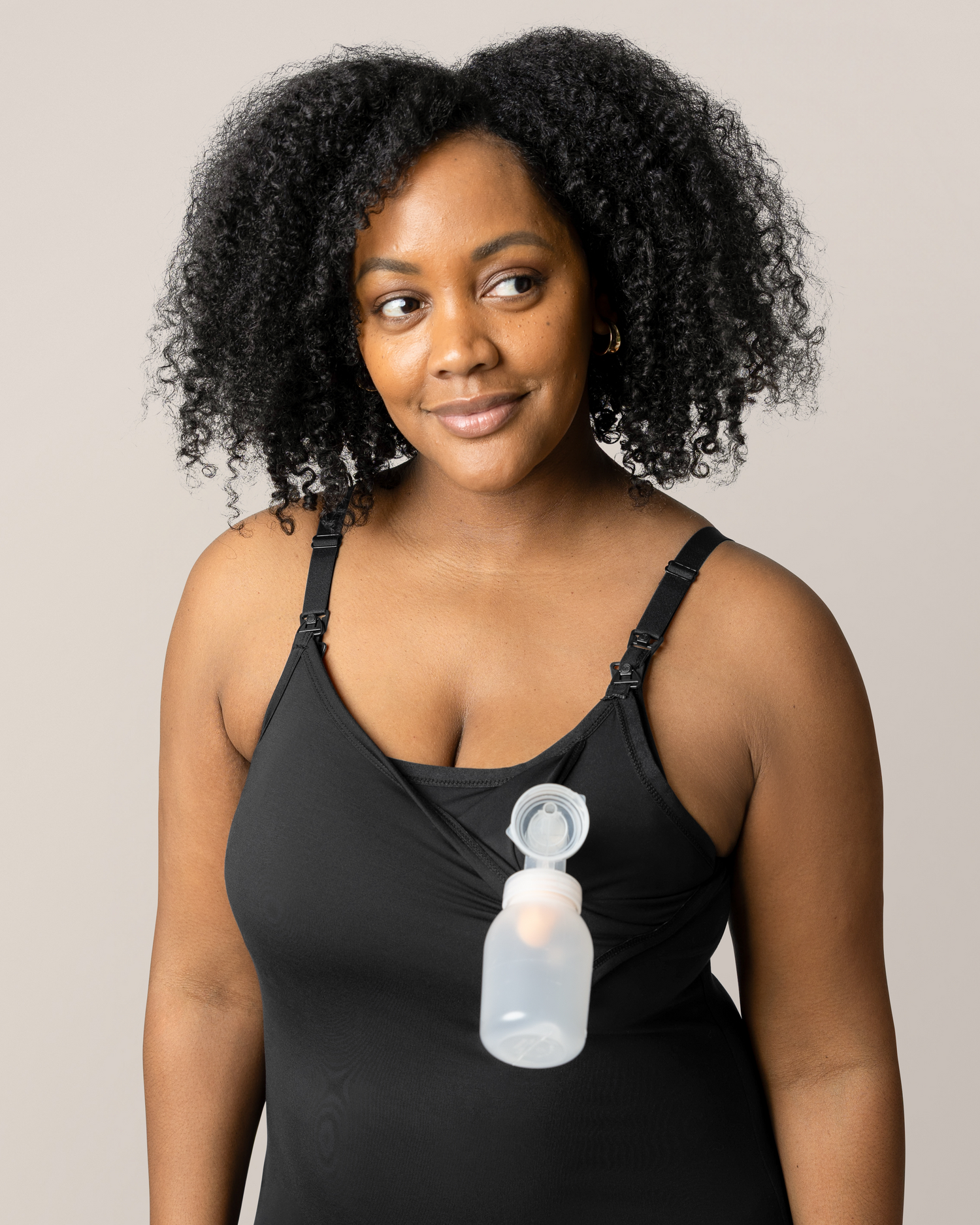 Front view of model wearing the Stella Hands-Free Pumping & Nursing Nightgown in Black, with pump inserted