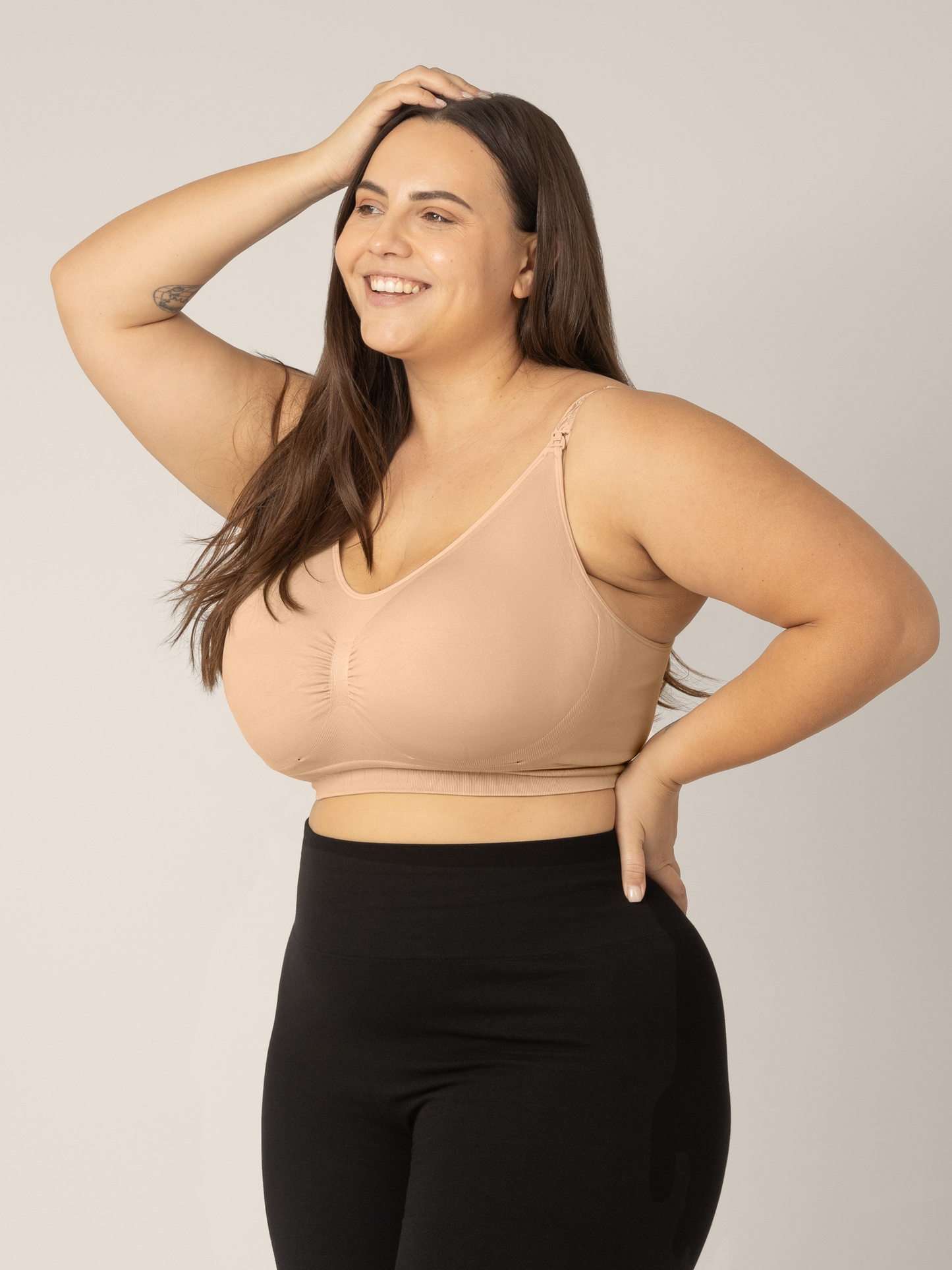Side view of model wearing the Sublime Nursing Bra in beige showing the Super-busty size range.