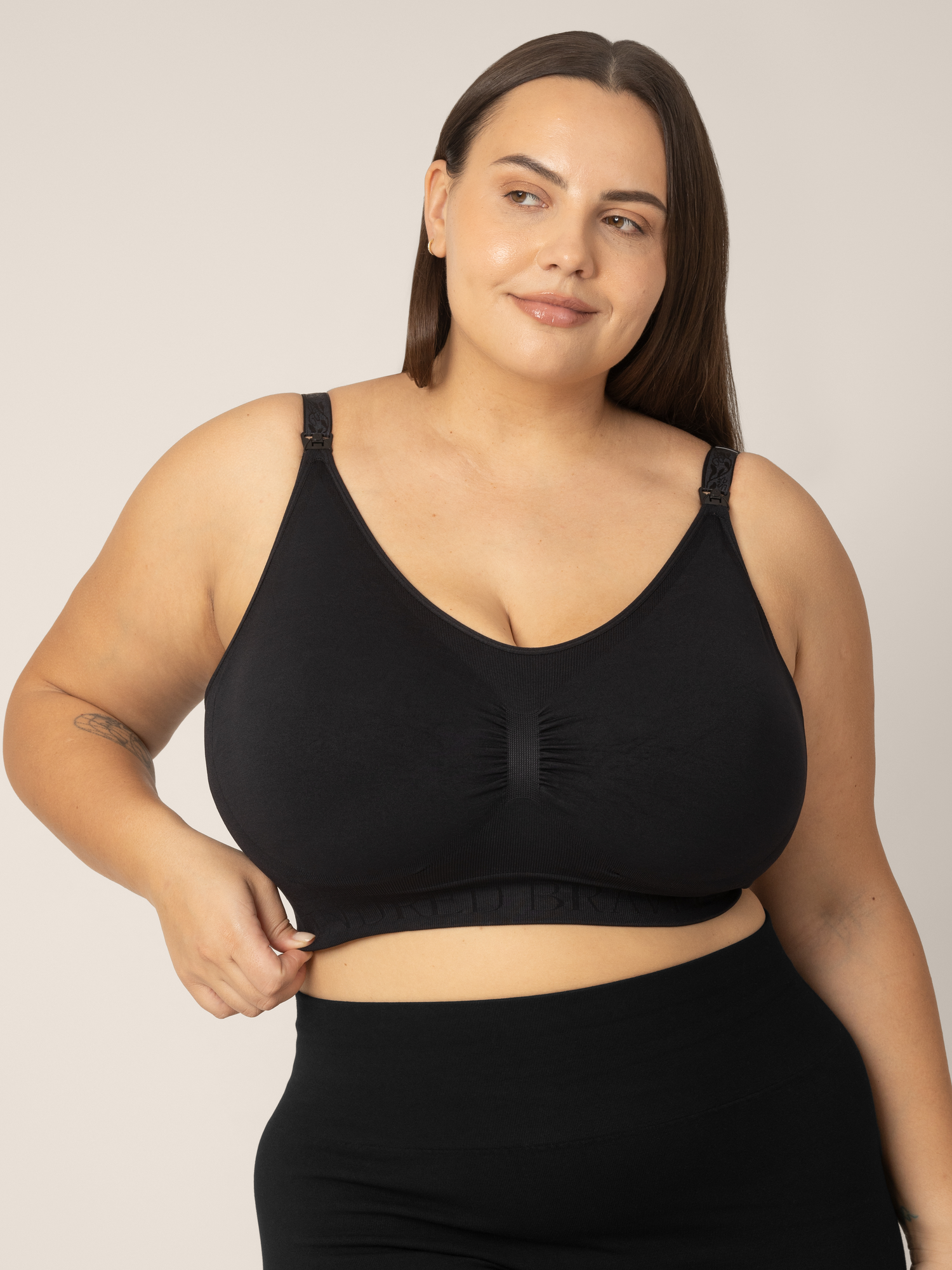 Super Busty model wearing the Sublime Hands-Free Pumping & Nursing Sleep and Lounge Bra in Black. @model_info:Anna is wearing an X-Large Super Busty.