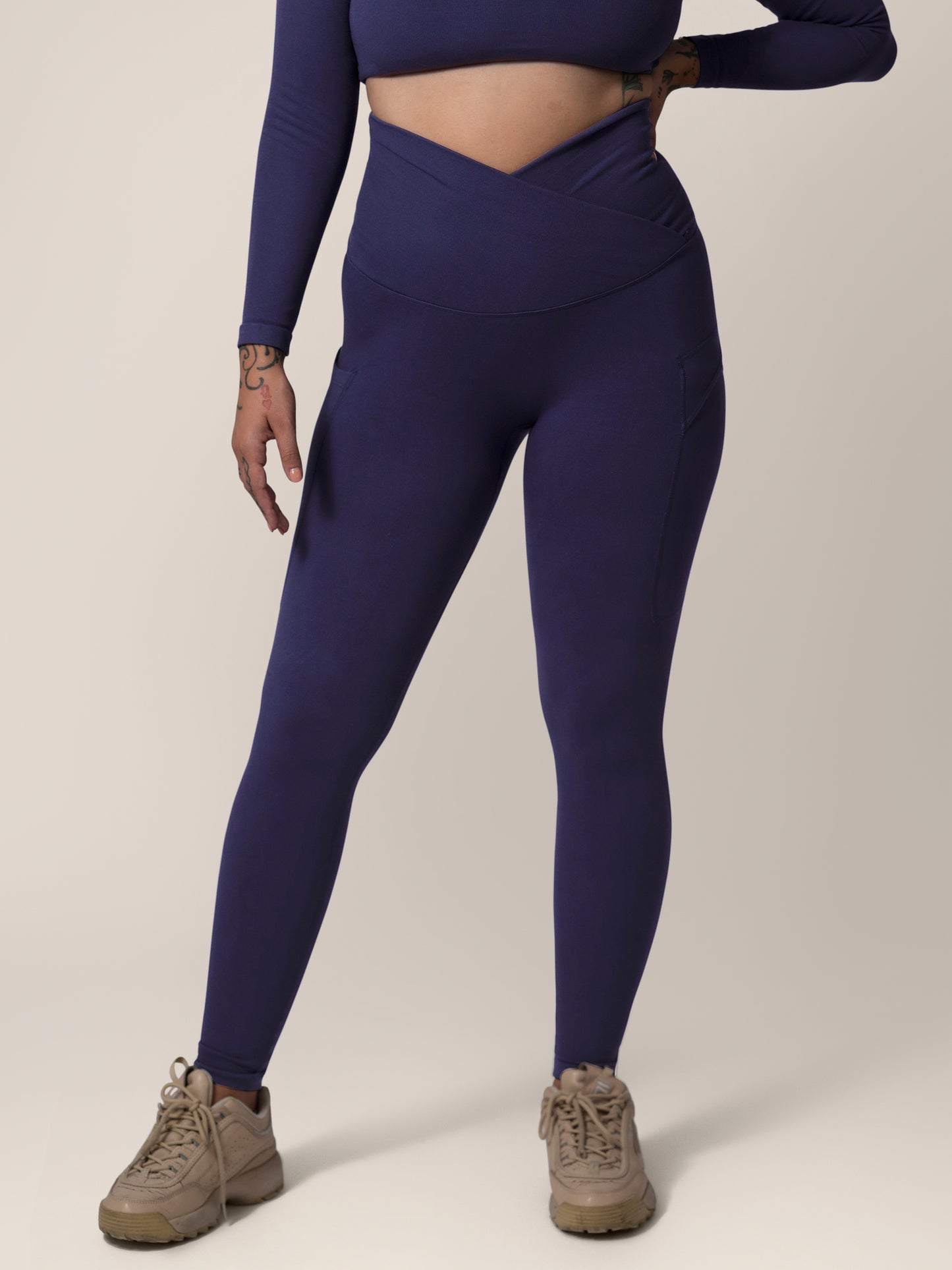 Front view of model wearing the Sublime®️ Bamboo Maternity & Postpartum Crossover Legging in Navy. @model_info:Anna is 5'6" and wearing a Medium.