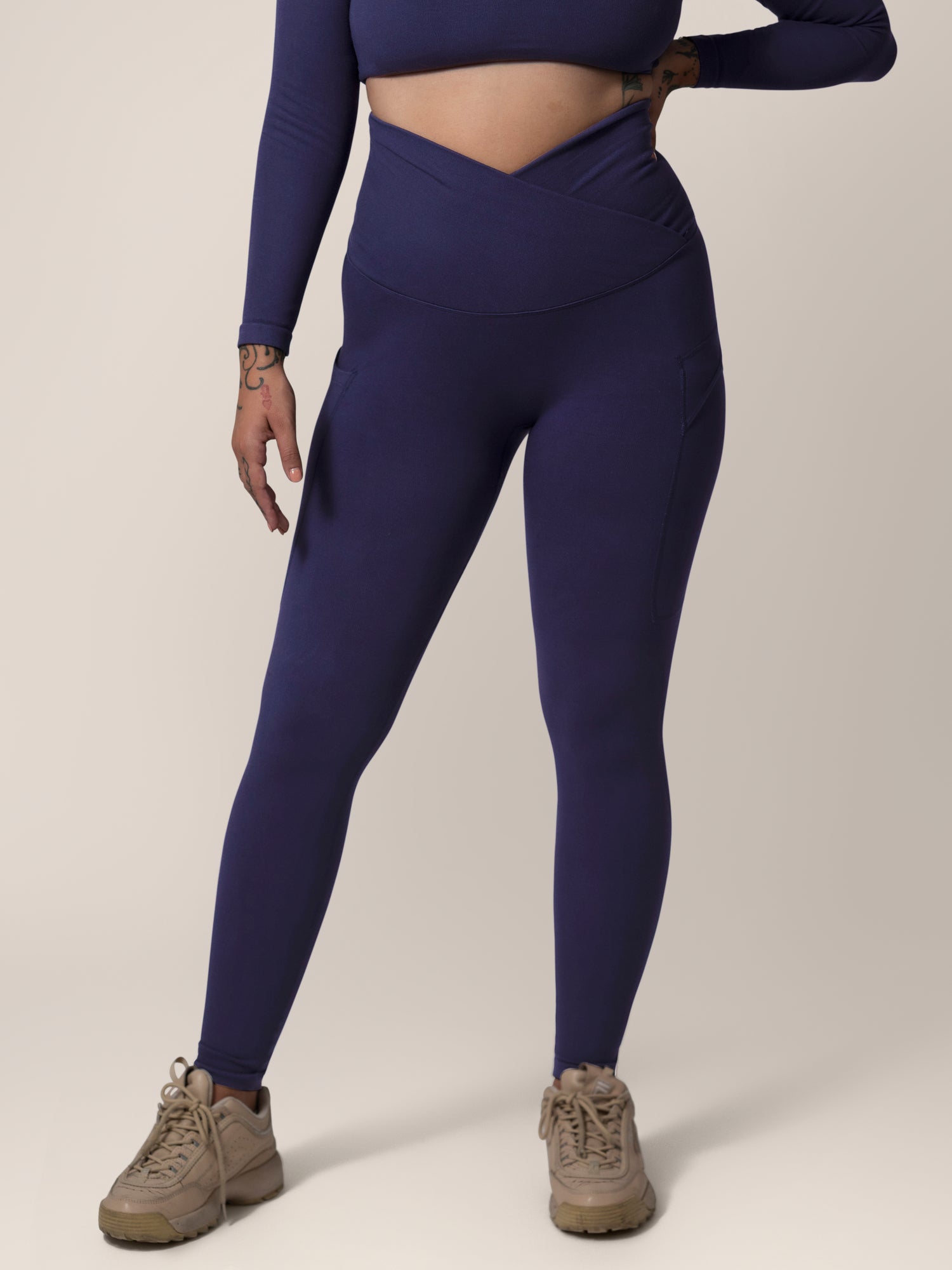 Front view of model wearing the Sublime®️ Bamboo Maternity & Postpartum Crossover Legging in Navy. @model_info:Anna is 5'6" and wearing a Medium.