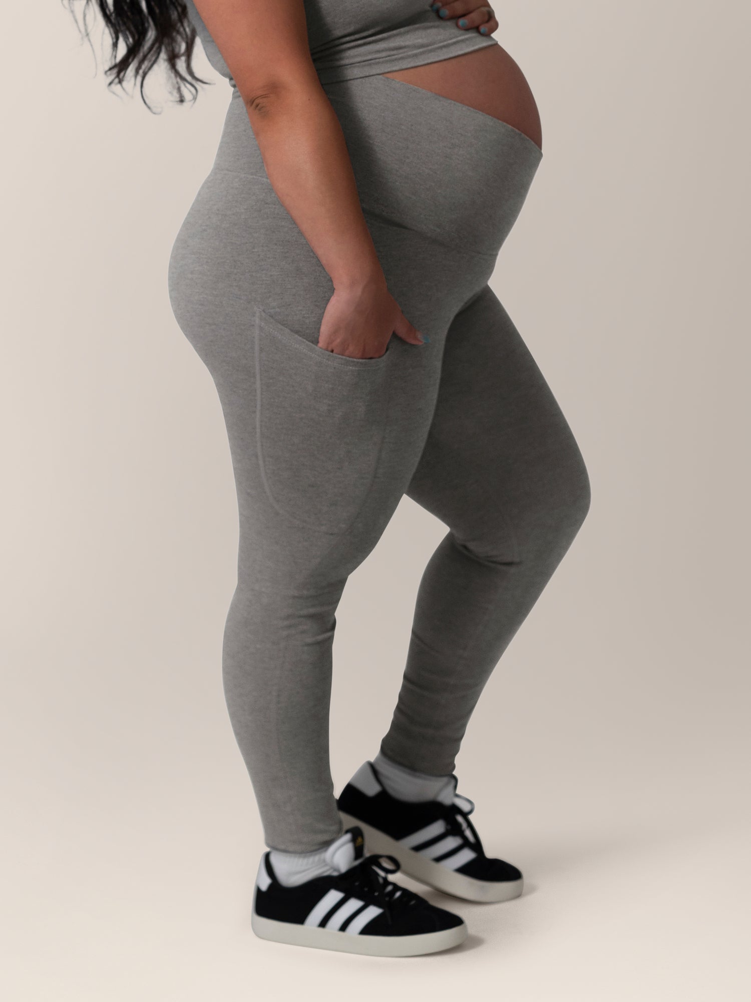 Side view close up of model wearing the Sublime®️ Bamboo Maternity & Postpartum Crossover Legging in Charcoal