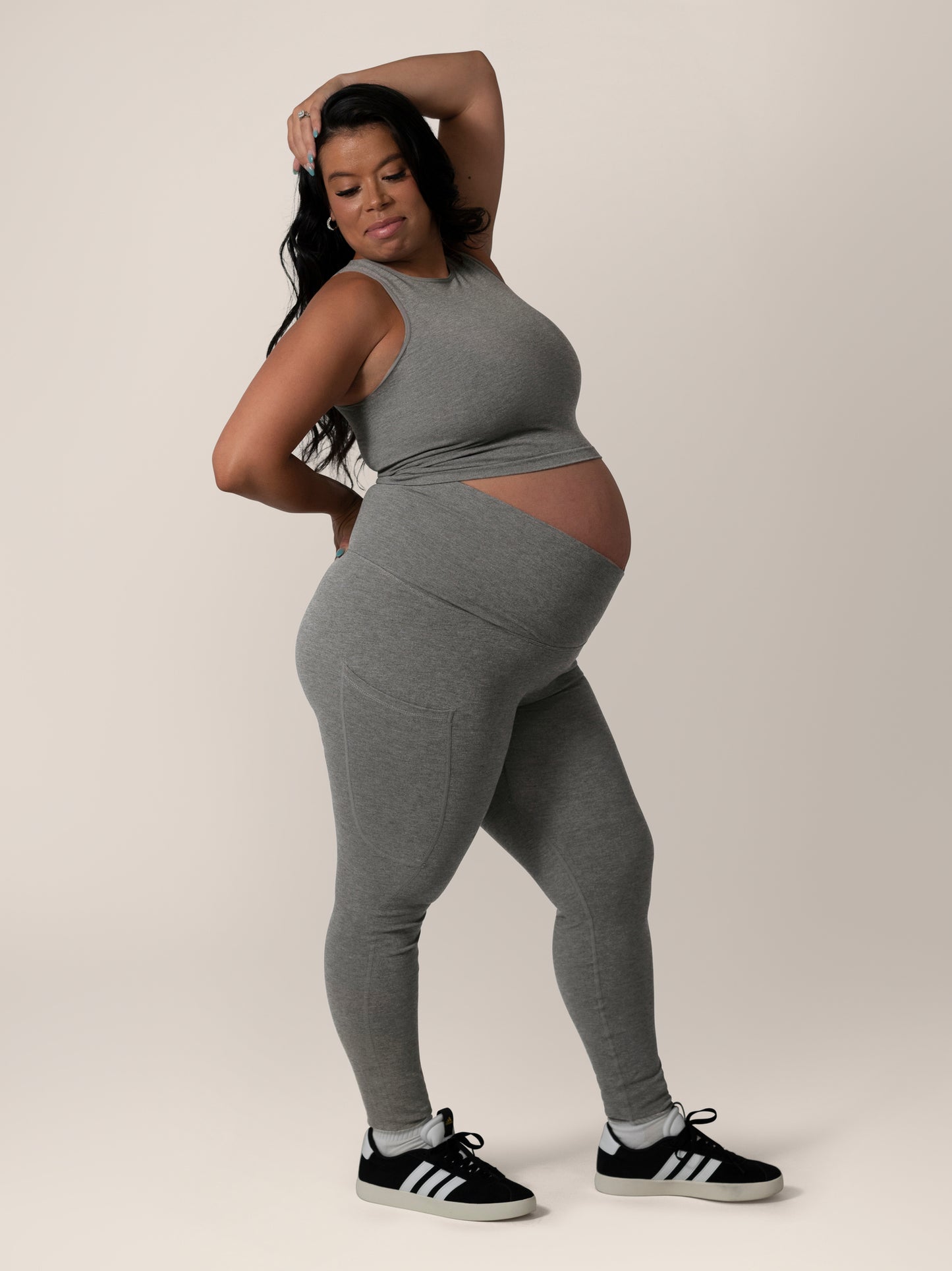 Side view of model wearing the Sublime®️ Bamboo Maternity & Postpartum Crossover Legging in Charcoal, paired with matching Sublime® Bamboo Maternity & Nursing Longline Bra. @model_info:Christina is 5'3" and wearing a Large.