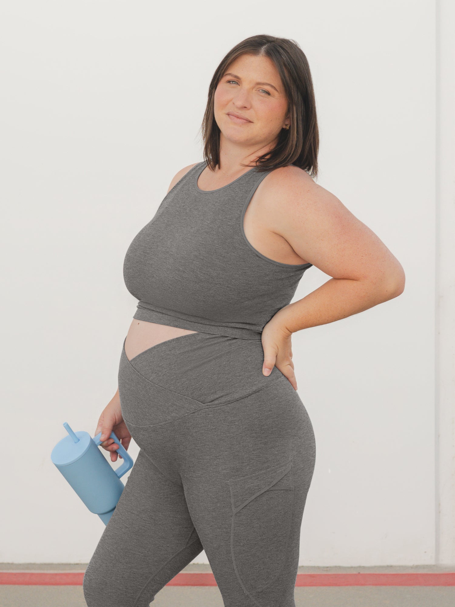 3/4 angle of model wearing the Sublime® Bamboo Maternity & Nursing Longline Bra in Charcoal, paired with matching Sublime® Bamboo jogger