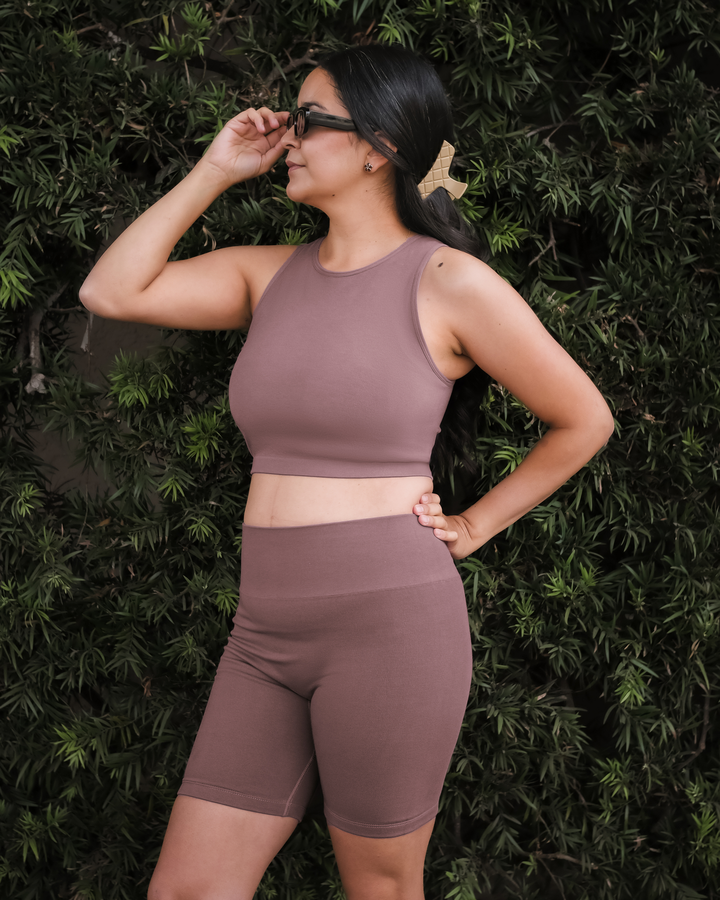 Model standing outside with hand on sunglasses, wearing the Sublime® Bamboo Hands-Free Pumping Longline Bra Top in Twilight, paired with matching Sublime® Bamboo Maternity & Postpartum Bike Short @model_info:Dama is wearing a Medium Busty.