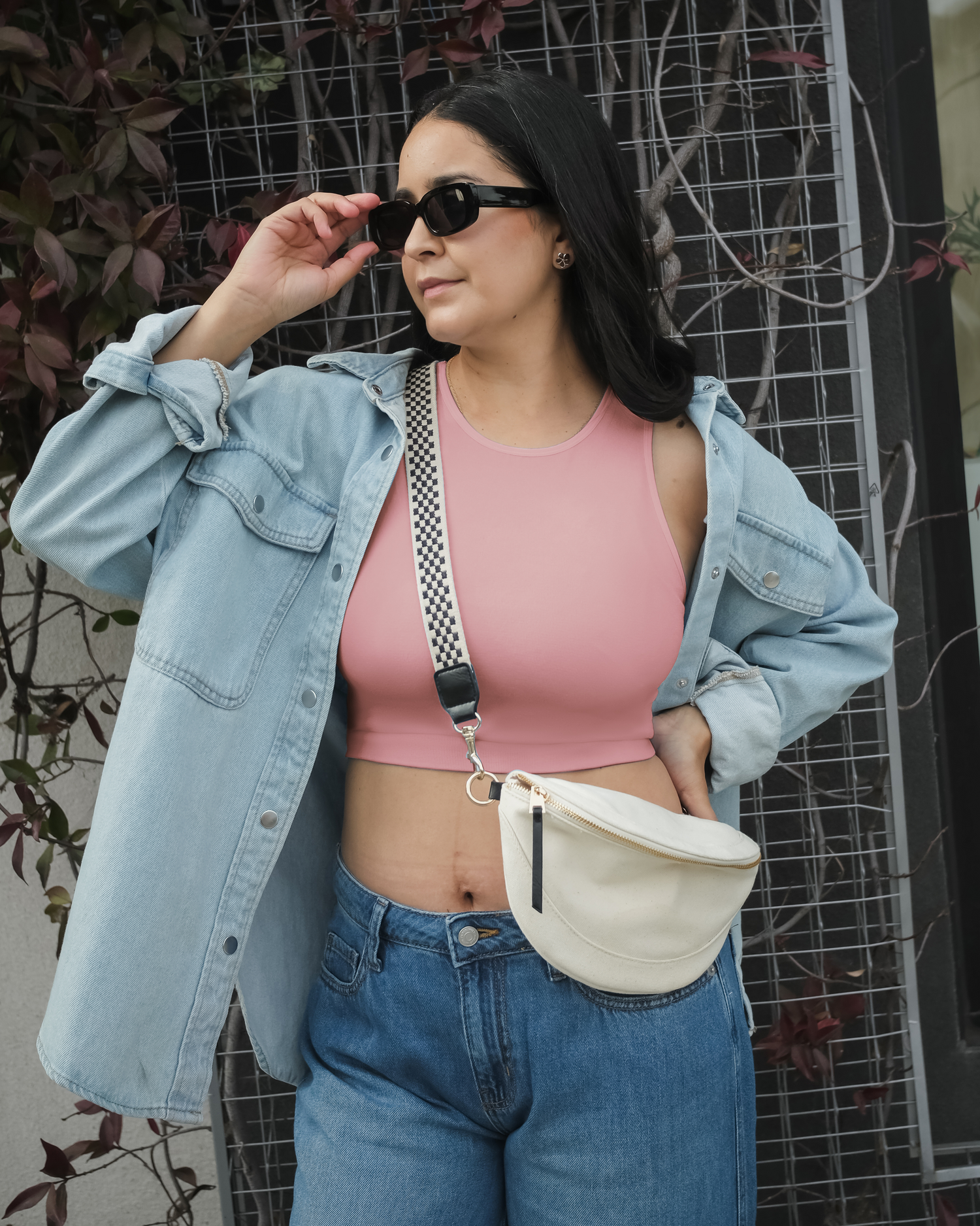 Model wearing the Sublime® Bamboo Hands-Free Pumping Longline Bra Top in Light Mauve, paired with open button-down shirt, jeans, and crossbody bag