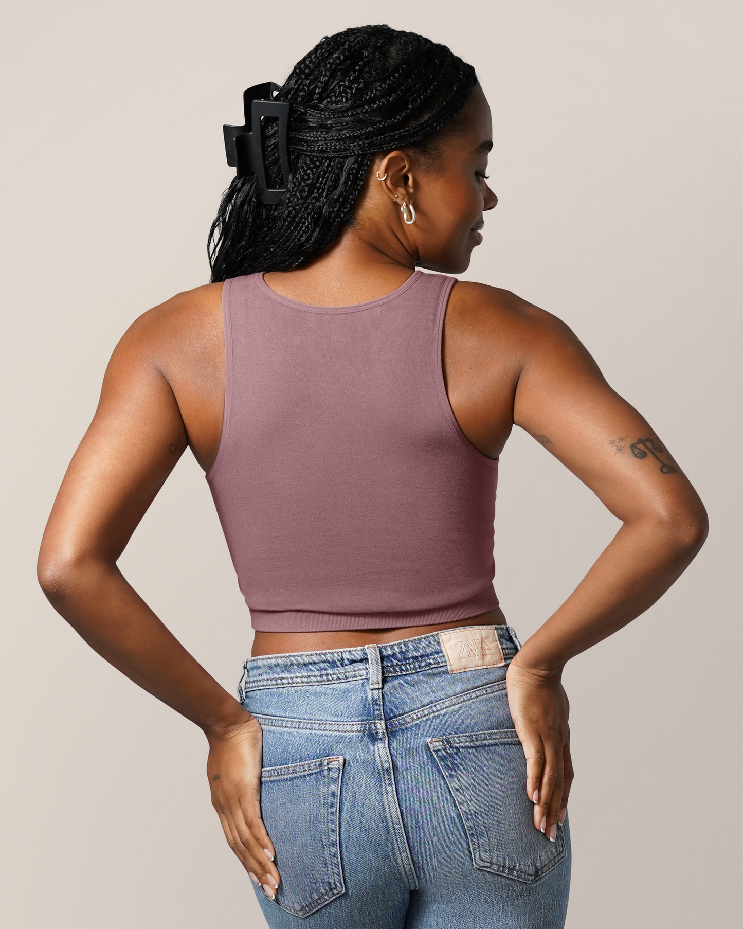 Back view of model wearing the Sublime® Bamboo Hands-Free Pumping Longline Bra Top in Twilight, paired with jeans