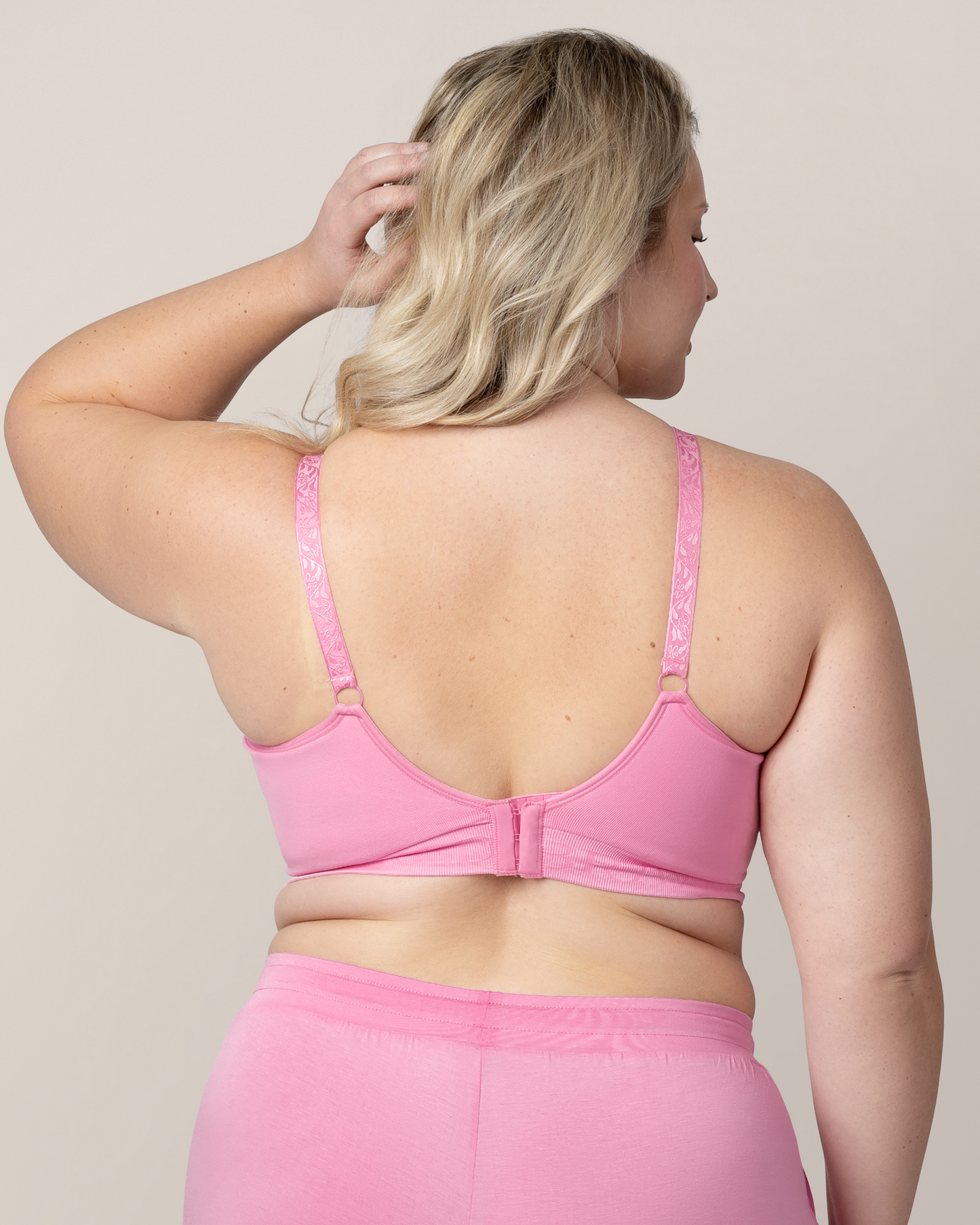 Back view of model wearing the Sublime® Hands-Free Pumping & Nursing Bra in Bubblegum with matching Everyday Lounge Joggers 