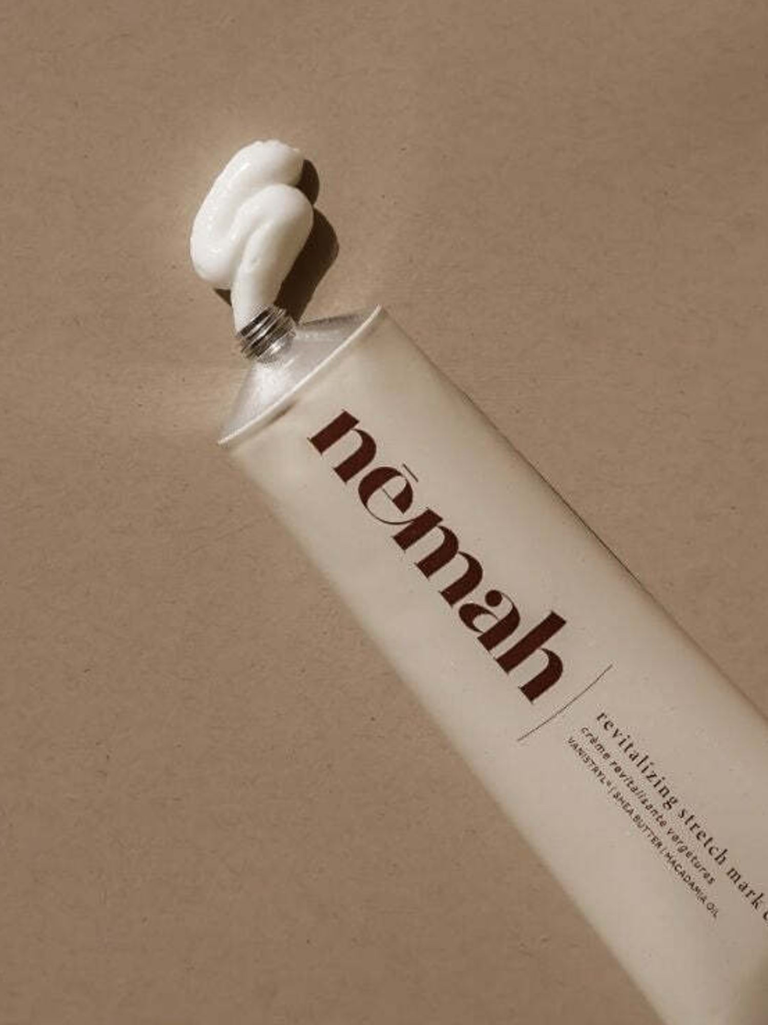 Nēmah - Revitalizing Stretch Mark Cream, showing some coming out of the tube | Kindred Bravely