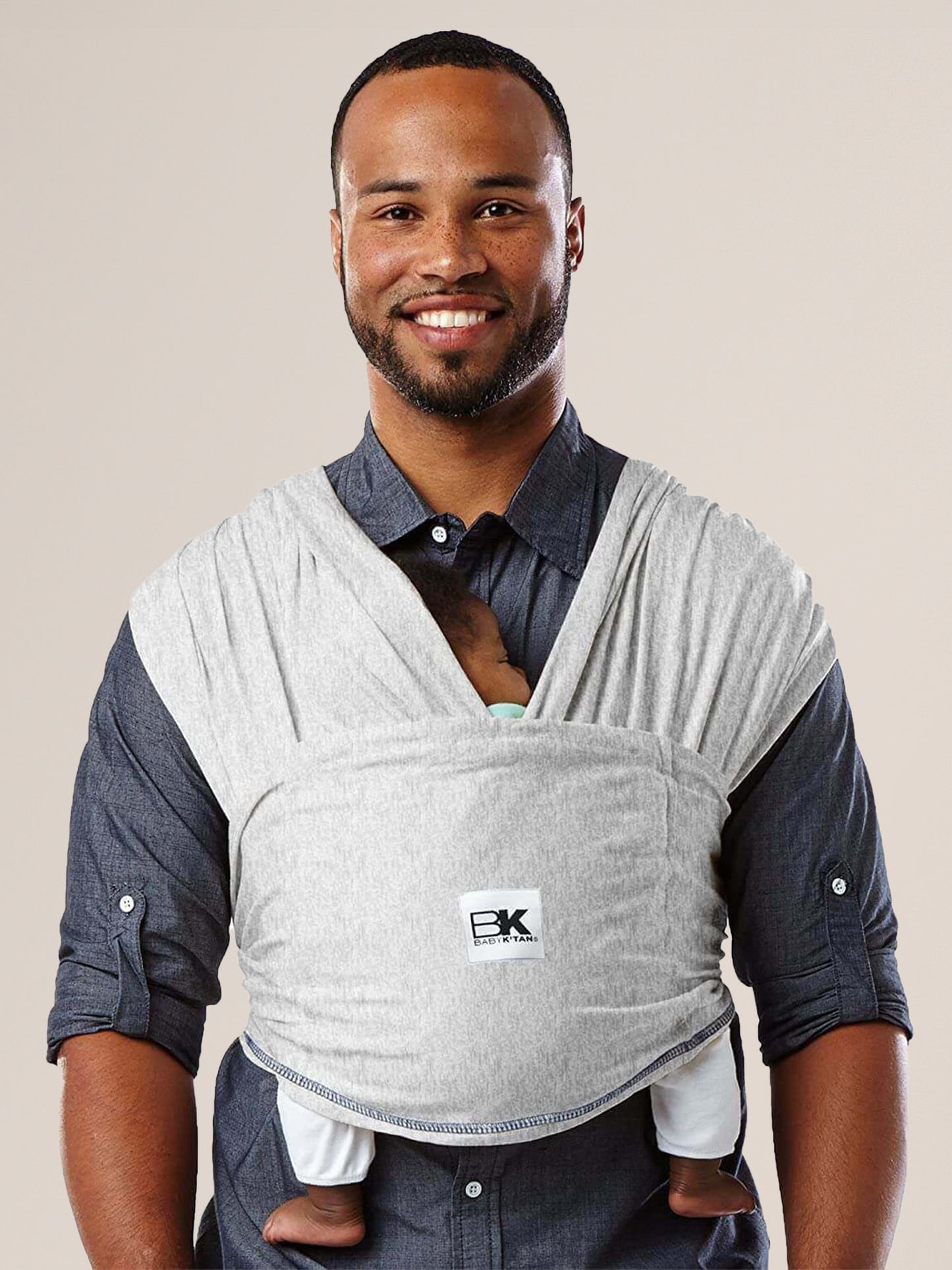 Model wearing baby in the Baby K'tan Original Baby Carrier in Heather Grey