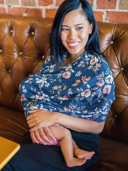 Model wearing and using the Bebe au Lait - 5-in-1 Multi-Use Nursing Cover in Midnight Floral, nursing baby