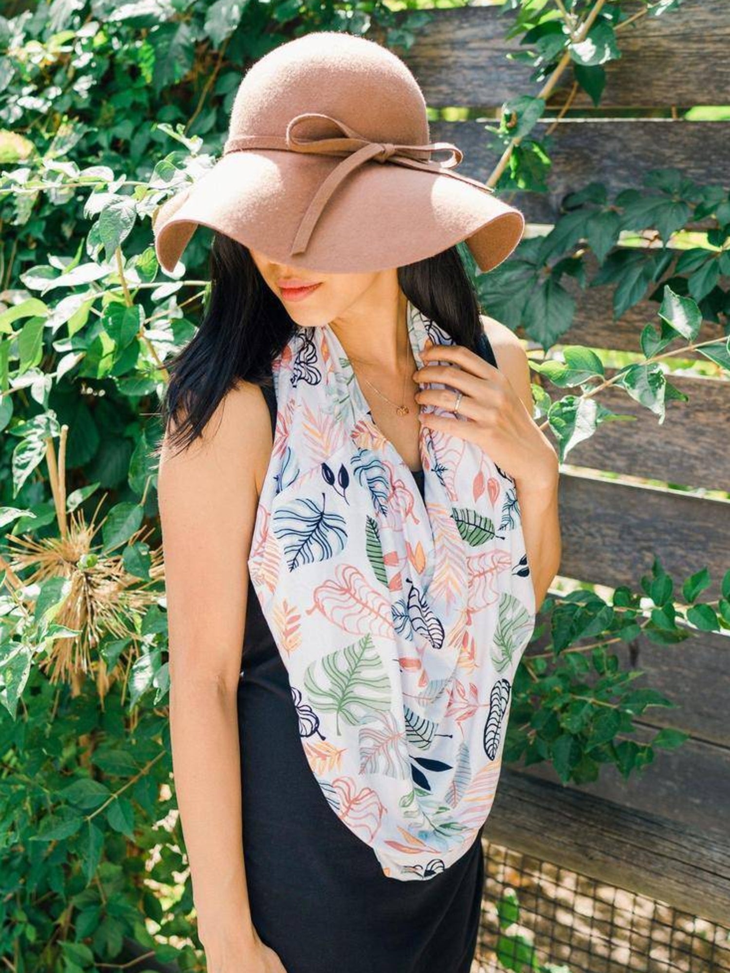 Model wearing the Bebe au Lait - 5-in-1 Multi-Use Nursing Cover in Tropicana as an infinity scarf